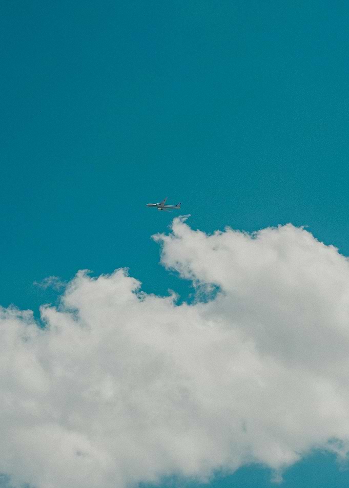 Airplane in Blue Sky with Clouds