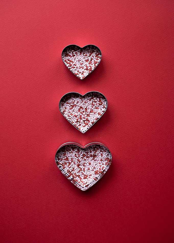 Three Hearts with Sprinkles on Red