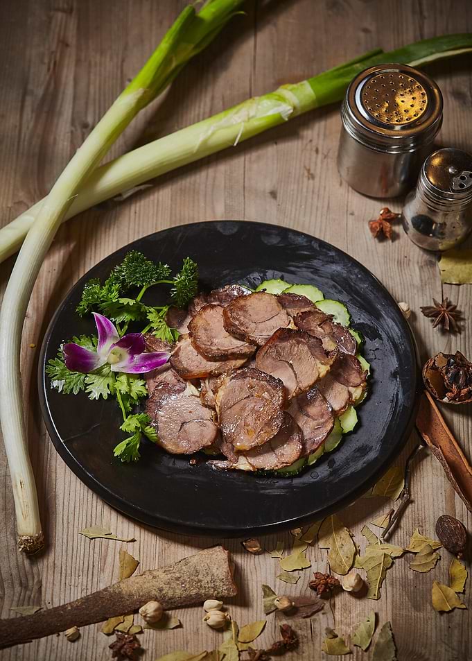 Sliced Beef Dish on Black Plate