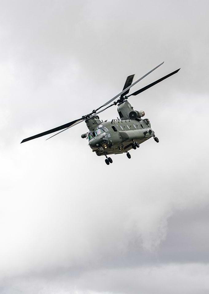 Chinook helicopter in flight against cloudy sky