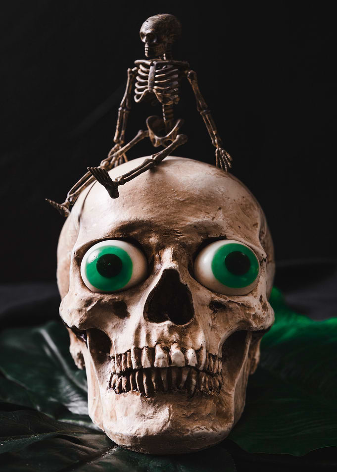 Skull with Green Eyes and Skeleton