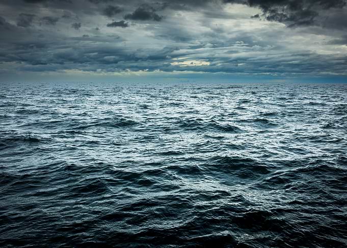 Dark Ocean Under Cloudy Sky