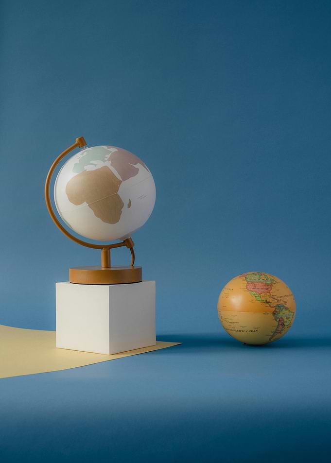 Two Globes on Blue Background