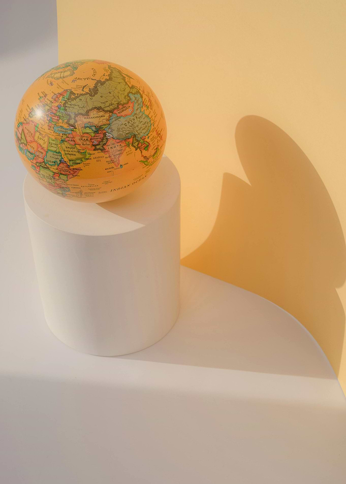 Globe on White Pedestal Still Life