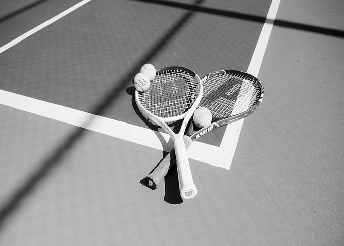 Tennis rackets and balls on court