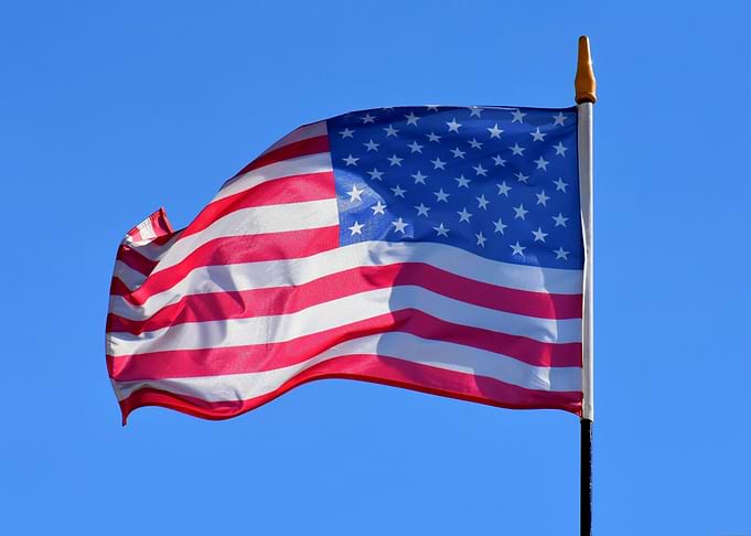 American Flag Waving Against Blue Sky