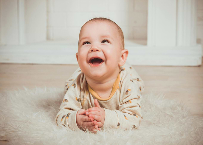 Happy Baby Lying on Fur Rug