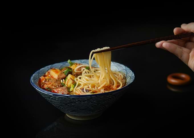 Noodle Bowl with Chopsticks on Black