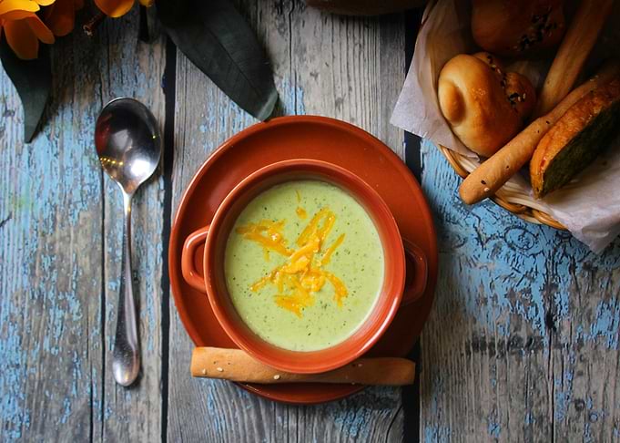 Creamy soup with breadsticks and rolls