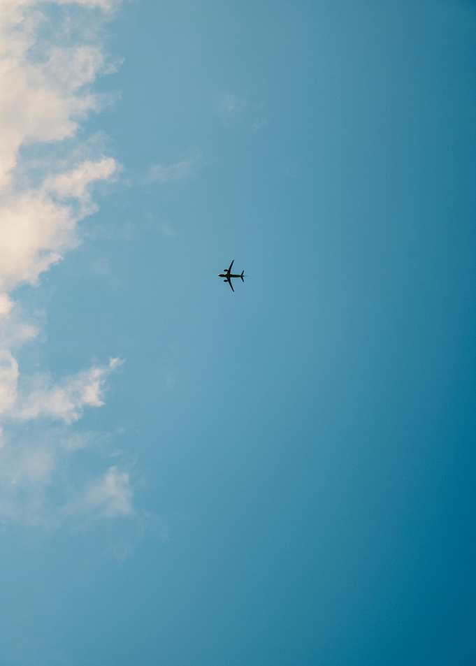 Airplane in Blue Sky with Clouds