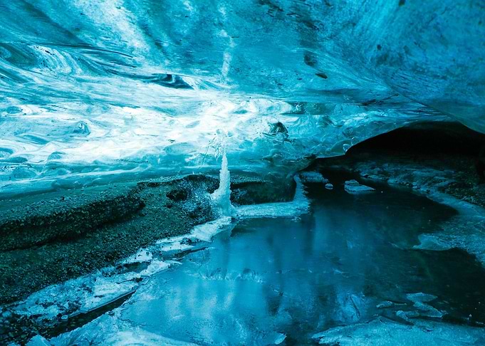 Ice Cave Interior with Water Reflection