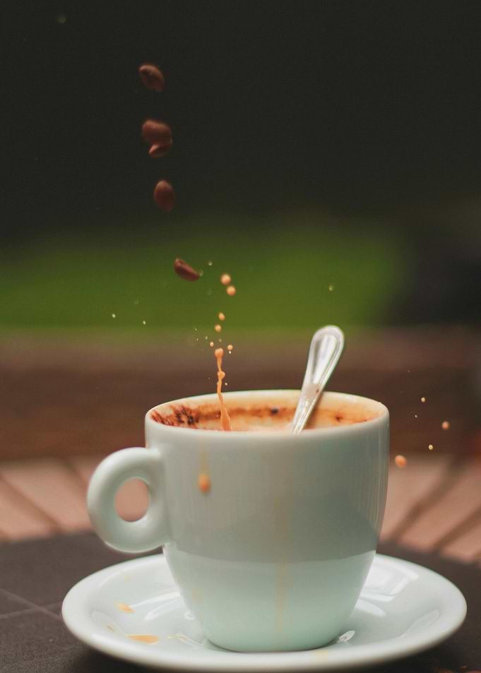 Coffee splash with beans falling