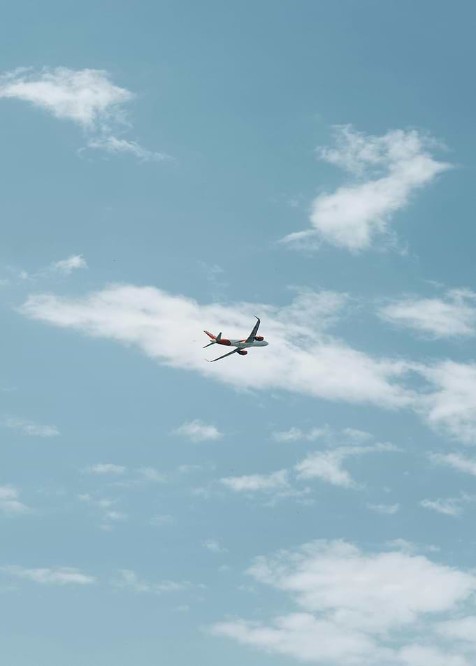 Airplane in a Cloudy Blue Sky
