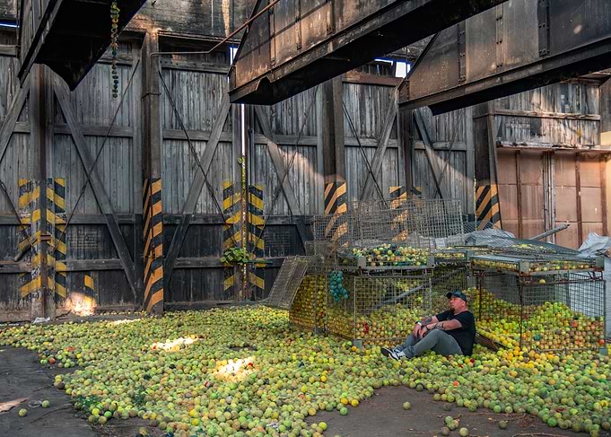 Man Surrounded by Tennis Balls