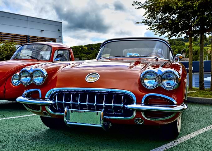 Classic Orange Cars in Outdoor Setting