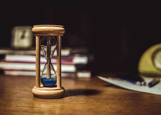 Hourglass on Wooden Desk