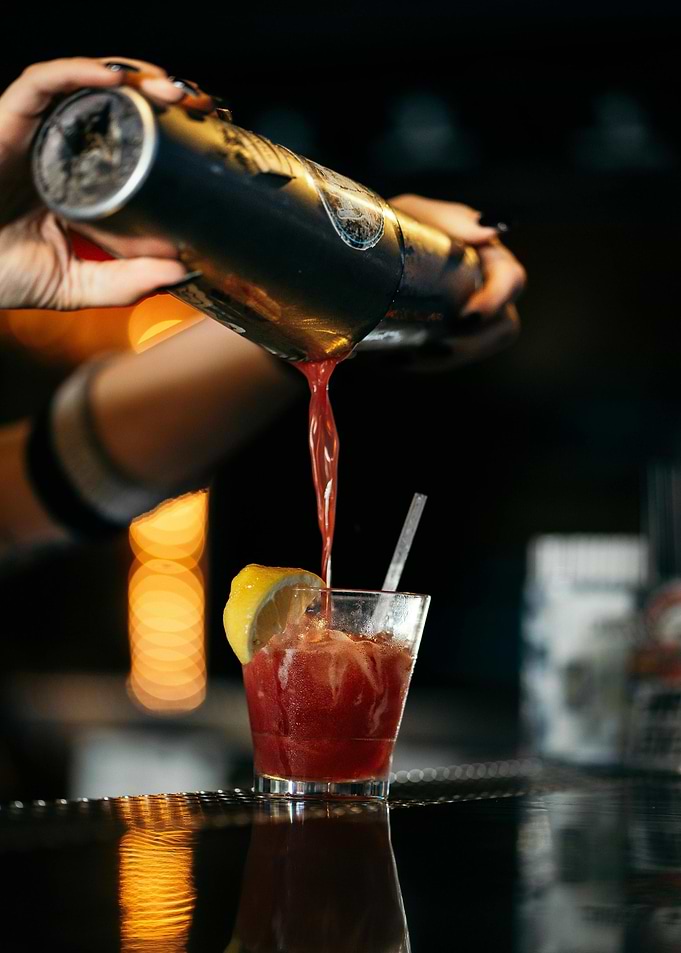 Cocktail being poured into glass