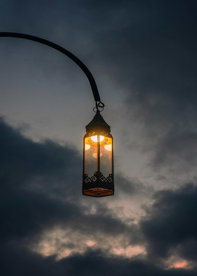 Illuminated Lantern Against Cloudy Sky