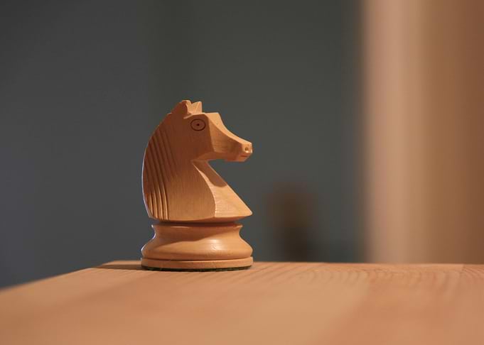 Chess Knight Piece on Wooden Surface