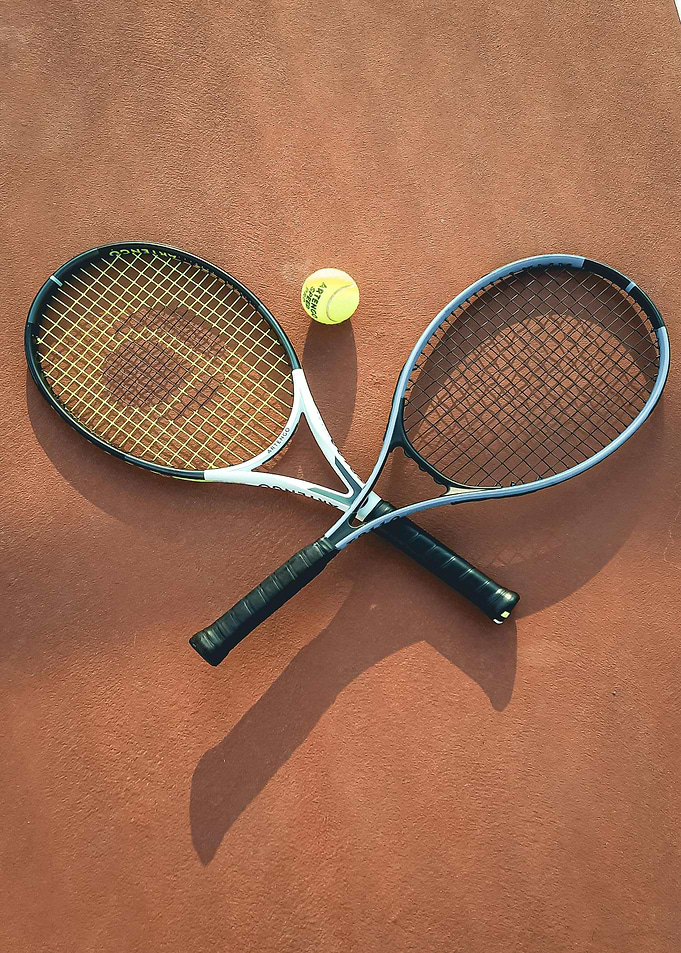 Tennis rackets and ball on court