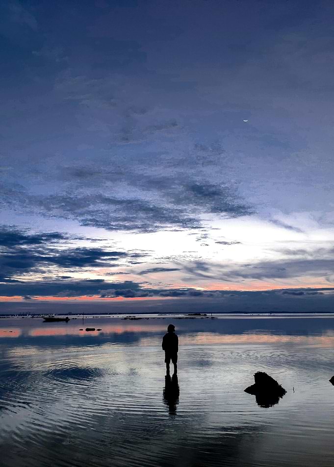 Silhouette on Water at Dusk