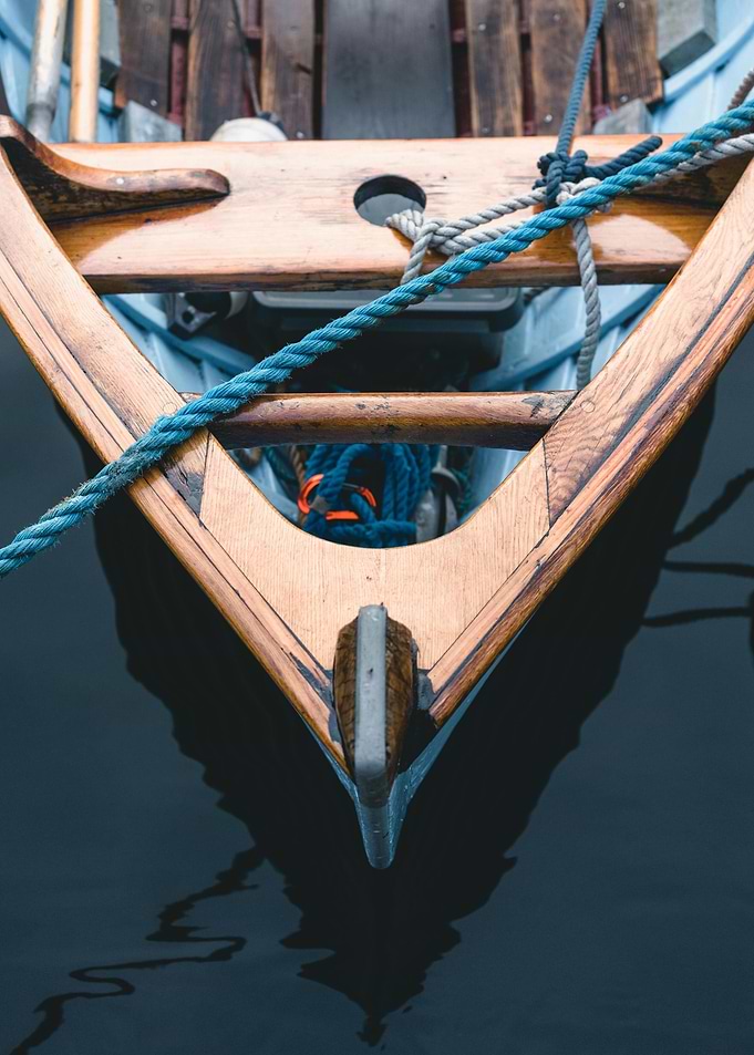 Wooden Boat Bow in Dark Water