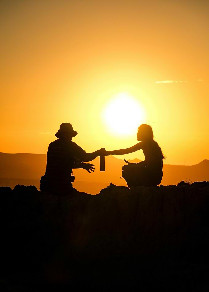 Sunset Silhouette: Sharing a Drink