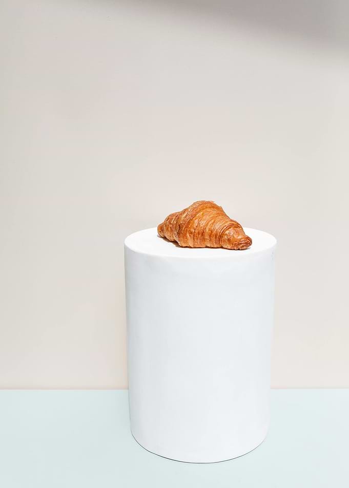 Croissant on White Pedestal