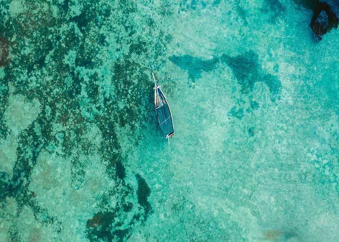 Aerial view of boat in turquoise water