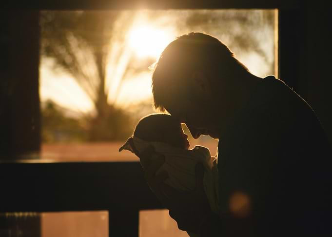 Father and Newborn Silhouette at Sunset