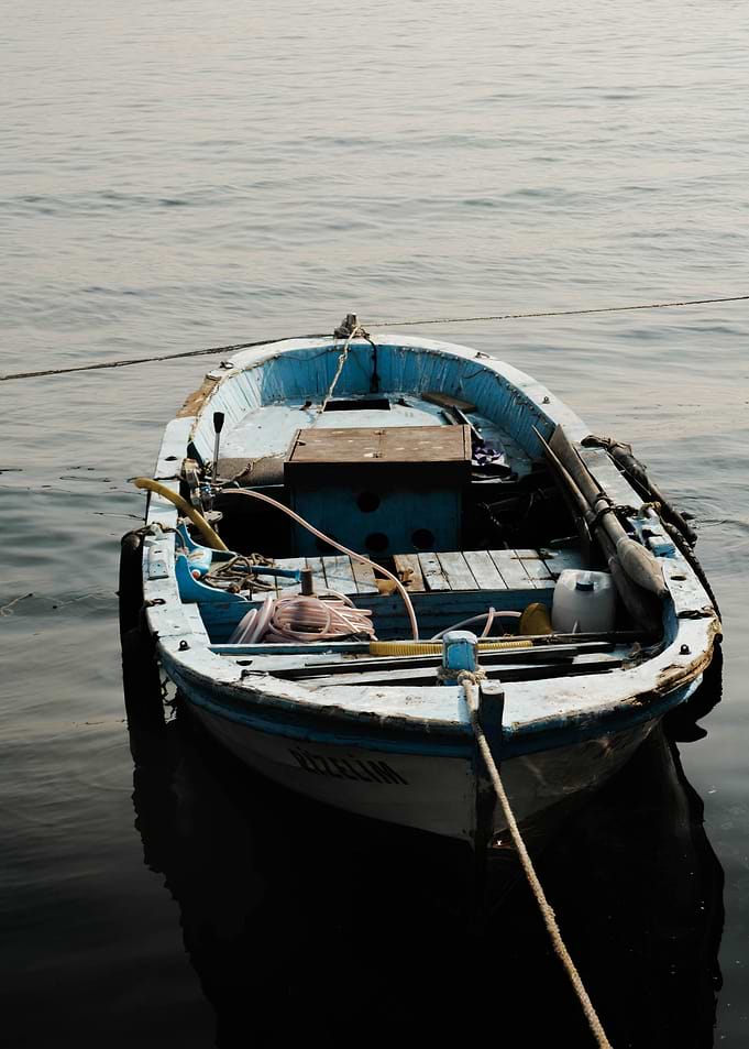 Small Blue Fishing Boat on Water