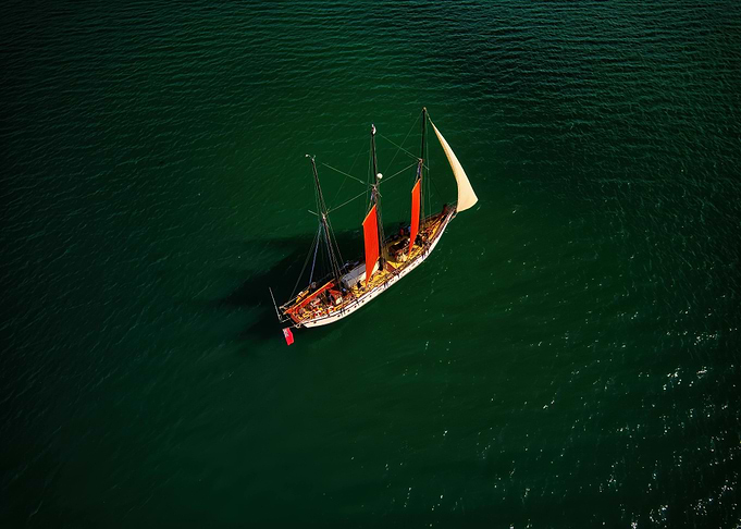 Sailing ship on green water