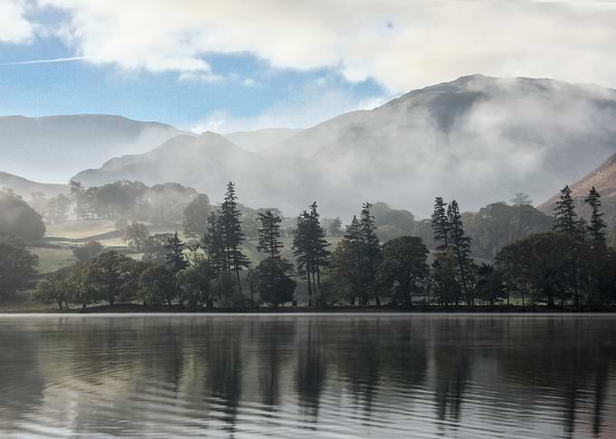 Misty Lake Landscape with Mountain Backdrop
