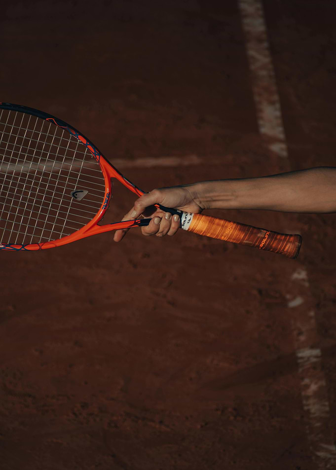 Tennis racket on clay court