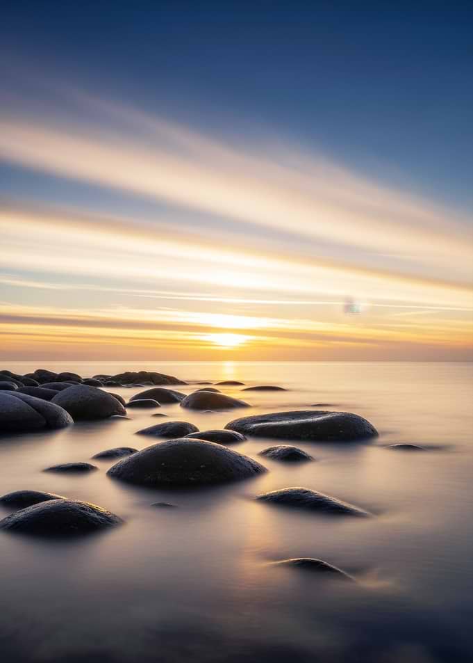 Sunset over rocky beach