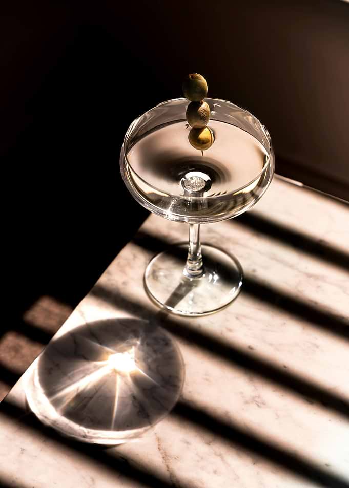 Martini with Olives on Marble Table