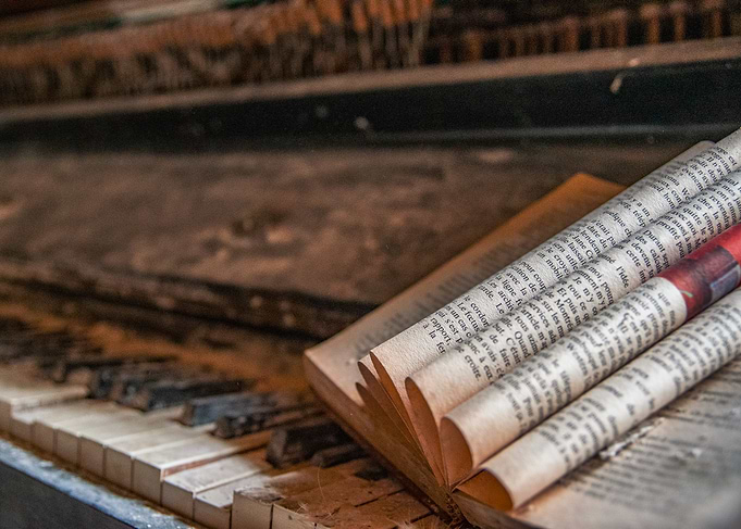 Old Piano with Rolled Newspaper Sheets