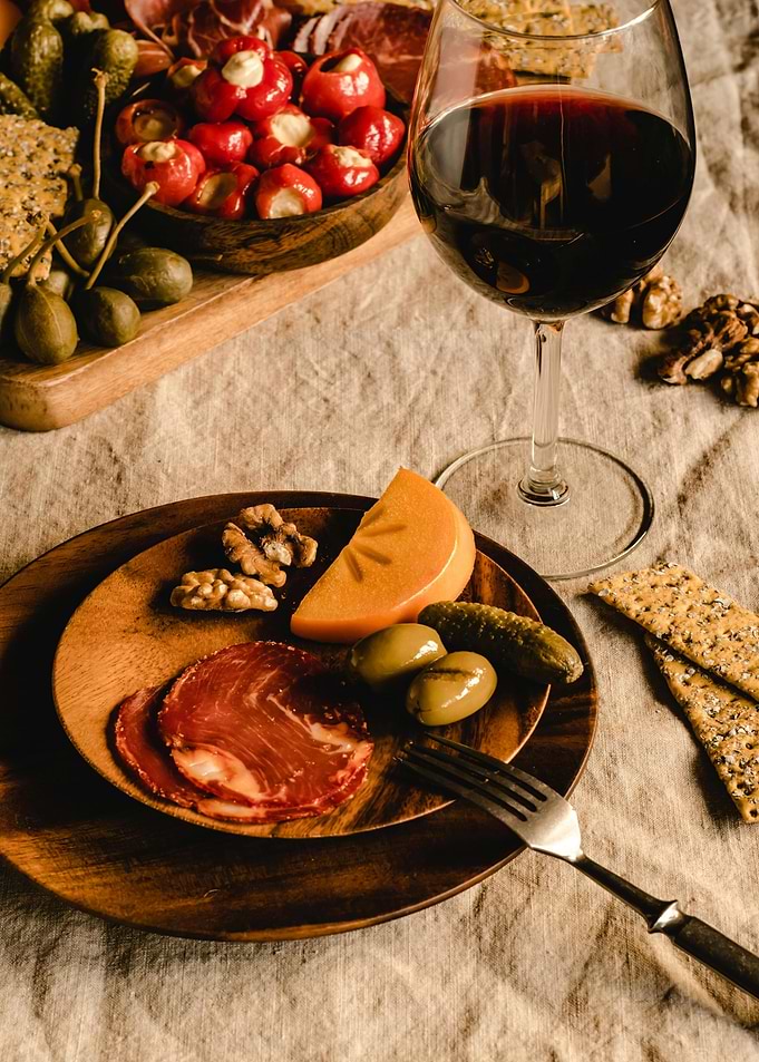 Charcuterie board with wine and snacks