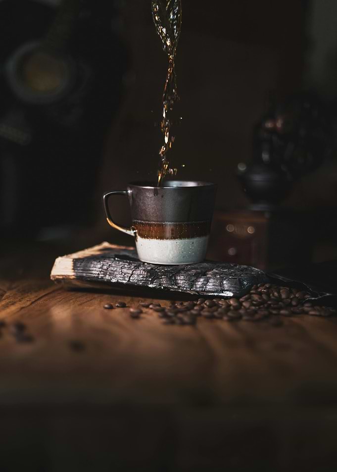 Pouring Coffee into a Striped Mug