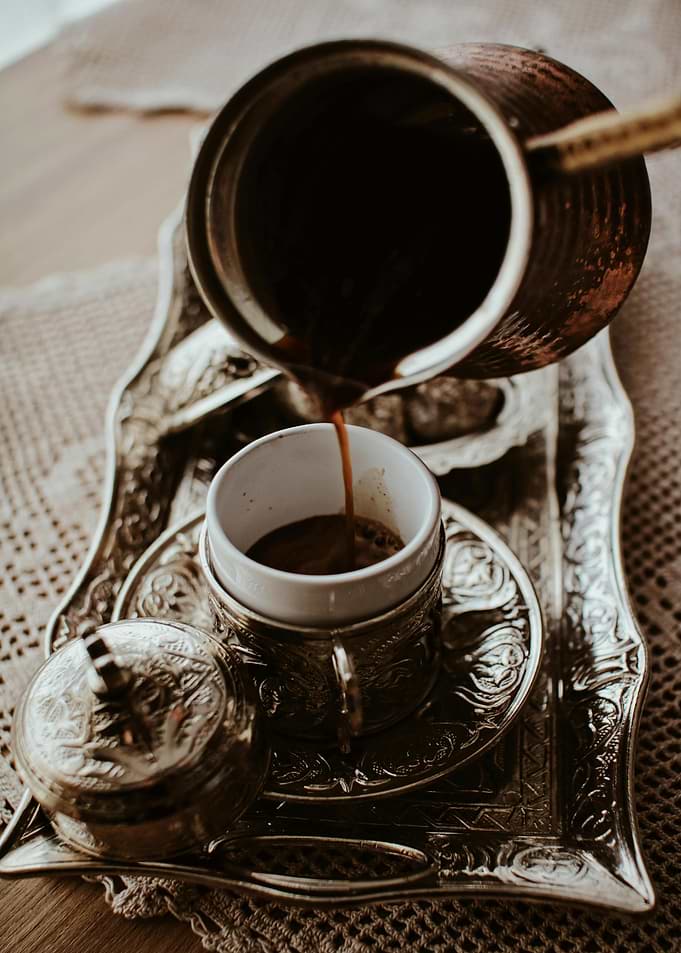 Pouring Turkish Coffee into ornate cup