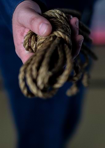 Hand Holding Brown Rope