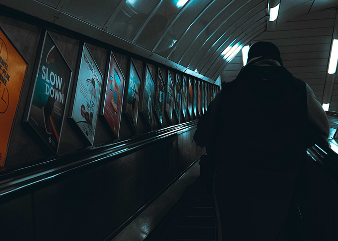 Subway Escalator with Posters and Person