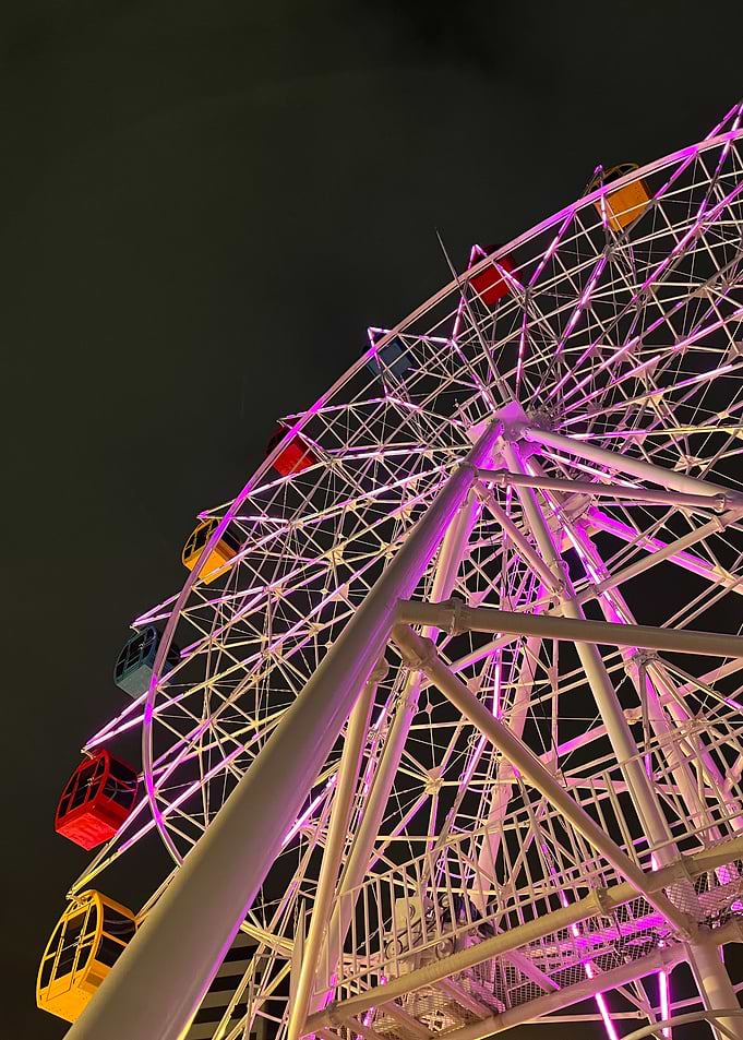 Ferris wheel at night with pink lights