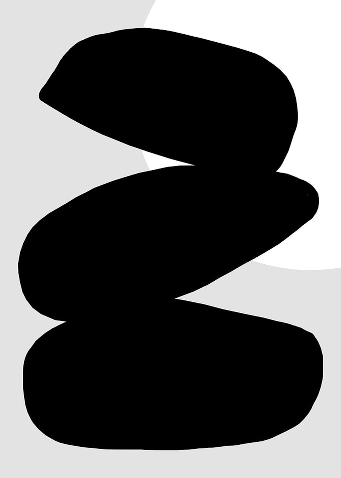 Black Stones Stacked on Gray Background