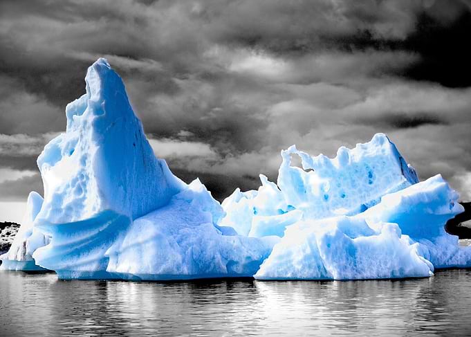 Blue Iceberg in Black and White Landscape