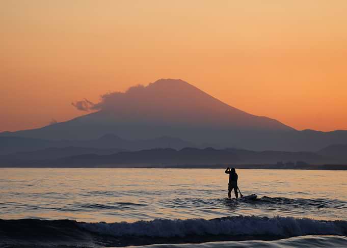 Mount Fuji at sunset with surfer