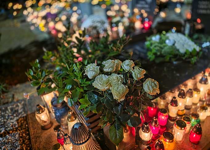 Cemetery at Night with Candles and Flowers