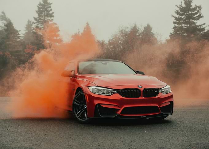 Red BMW with Orange Smoke