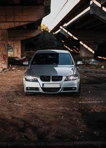 Silver BMW under a bridge