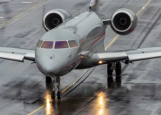 Silver Private Jet on Wet Runway